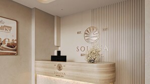 Ein moderner Hotelrezeptionstresen mit einem Logo und dem Jahr 2025.