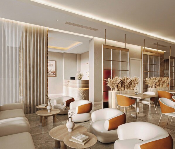 A modern hotel lobby with sofas, tables, and a reception desk. - L'Signature Tho Thap Hotel  (Hanoi)