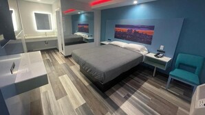 A modern hotel room with a large bed, bedside tables, a desk, and a chair. - La Palma Motel - South Gate - LA area (South Gate)