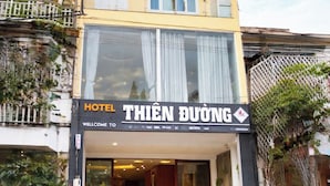 A hotel named "THIEN DUONG" with a yellow facade, large windows, and a welcoming entrance. - Thien Duong Hotel Hue (Hue)