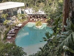 A pool area with lounge chairs and a small garden. - Dk Jade 3, Your Exclusive Refuge in Tulum (Tulum)