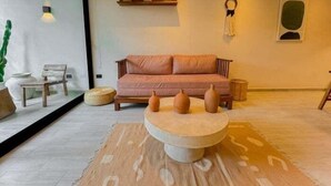 A modern living room with a sofa, a coffee table, and decorative vases. - Dk Jade 3, Your Exclusive Refuge in Tulum (Tulum)