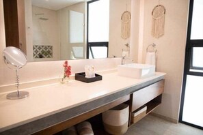 A modern bathroom with a large mirror, a white sink, and a vanity with storage. - 106D PANOR, Modern and incredible studio apartment (Tulum)