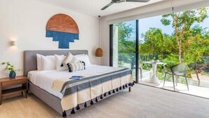 A modern bedroom with a large bed, a ceiling fan, and a view of greenery outside. - B409 CPL, Studio Jungle View-No Air Conditioning-2 (Tulum)