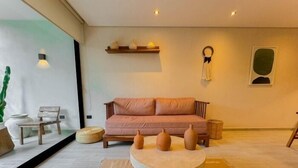 A modern living room with a sofa, a coffee table, and decorative vases. - Dk Jade 3, Your Exclusive Refuge in Tulum-2 (Tulum)