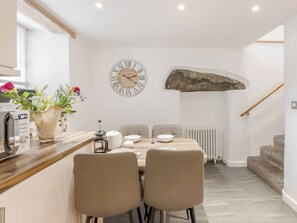 A modern kitchen with a wooden countertop, a coffee machine, and a vase with flowers. - 3 bedroom accommodation in Keswick (Keswick)