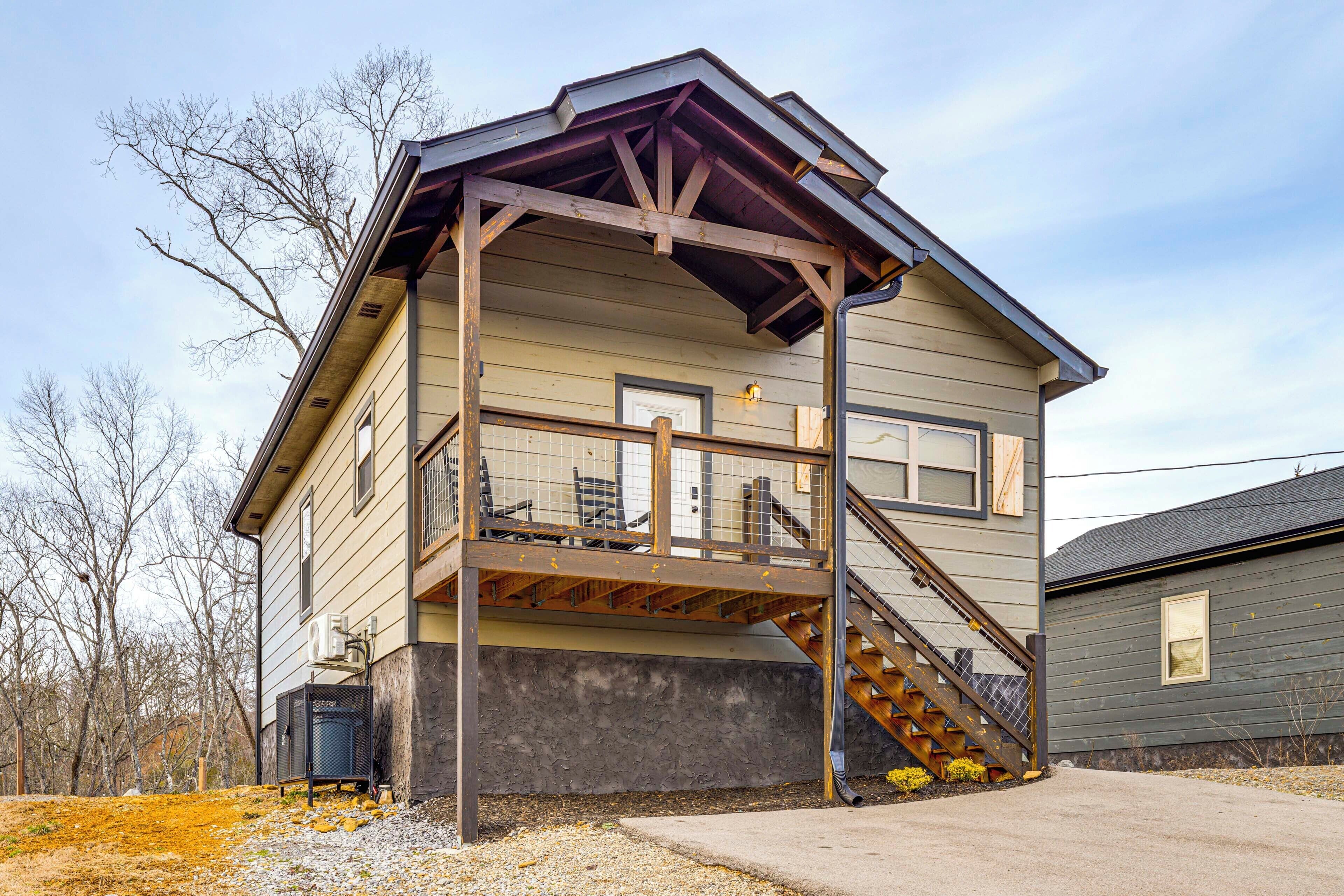 A two-story house with a balcony and a staircase leading to the upper floor.