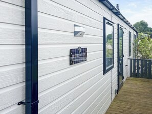 A house with white siding, a nameplate reading "EDMONTON," and a black mailbox. - Edmonton Lodge - UK50308 (Doublebois, near Liskeard)