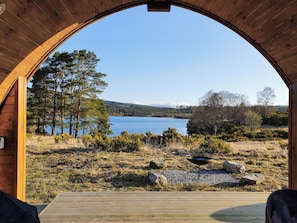 A wooden archway leading to a lakeside view with a barbecue setup. - 1 bedroom accommodation in Cassafuir (Cassafuir)