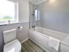 A modern bathroom with a toilet, a shower with a glass door, and a bathtub. - 3 bedroom accommodation in Fitling, near Burton Pidsea (Fitling, near Burton Pidsea)