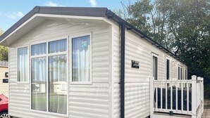 A mobile home with a white exterior, large windows, and a white porch. - 3 bedroom accommodation in New Quay (New Quay)