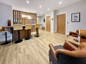 A modern bar area with wooden slats and bar stools. - Blairmains Farmhouse (Stirling)