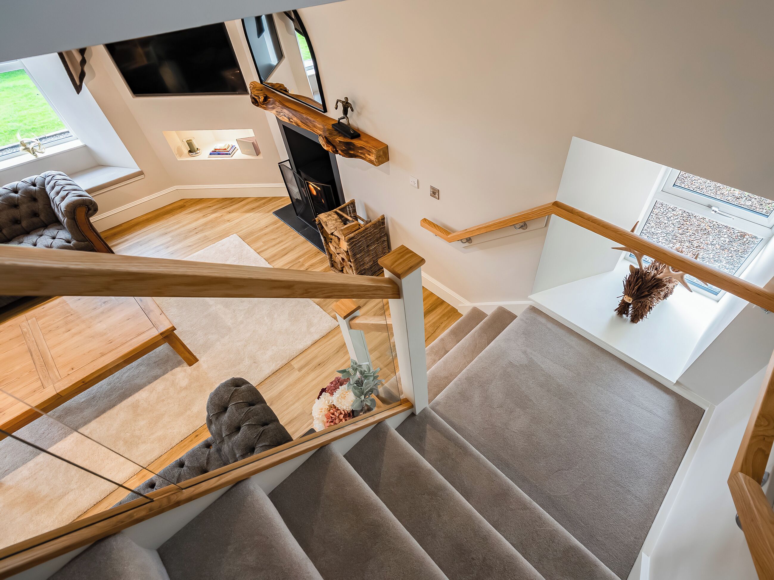A modern interior with a staircase, a fireplace, and a sofa.