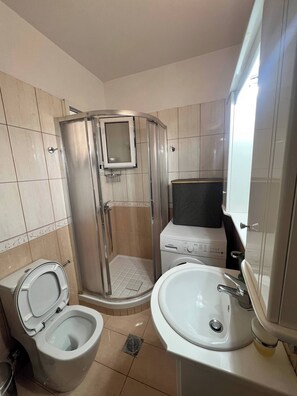 A bathroom with a shower, toilet, and sink. - Windsor Place - Self Check in With Code (Vari-Voula-Vouliagmeni)