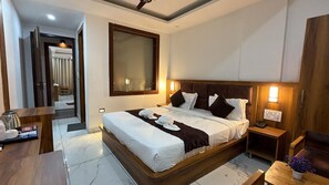 A modern hotel room with a large bed, bedside tables, a desk, and a chair. - HOTEL FALLS STREET BY DC HILLS (Rishikesh)