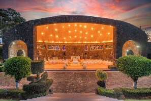 An outdoor amphitheater with stone arches, a stage with chairs, and a seating area. - Gallaecia House in Tepoztlán: 6 bedrooms, breakfast included (Tepoztlan)