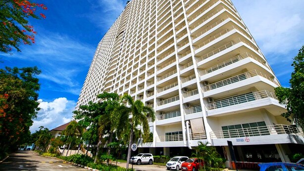 A tall, multi-story hotel with a uniform exterior and balconies on each floor. - Sea View Studio - Jomtien Beachfront - View Talay 8 (Muang Pattaya)