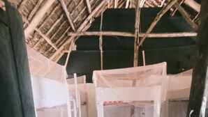 A rustic room with bunk beds, a ladder, and a thatched roof. - Babalao Beach Resort  Backpackers & Tent (Malindi)