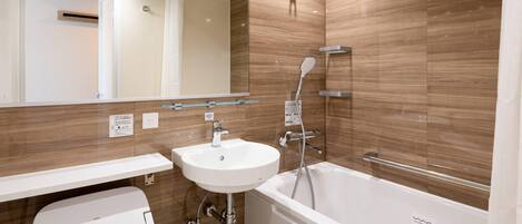 A modern bathroom with a bathtub, a sink, and a toilet.