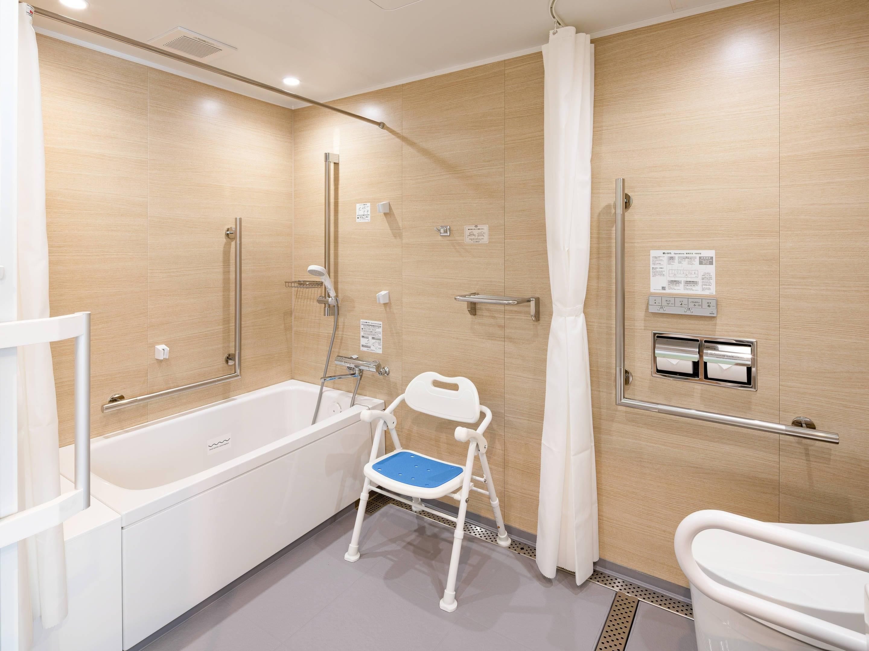 A modern bathroom with a bathtub, shower, and toilet.