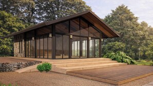 A modern house with a wooden deck, large glass windows, and a stone facade. - Montara Hotel, Tapestry Collection by Hilton (Ángeles)