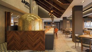 A modern interior with a herringbone wood floor, a central seating area with a mosaic dome, and a reception desk. - Montara Hotel, Tapestry Collection by Hilton (Ángeles)