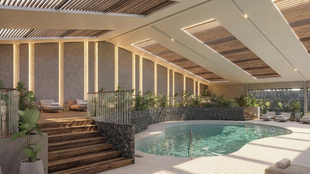 A modern indoor pool area with a stone wall, wooden steps, and lounge chairs. - Montara Hotel, Tapestry Collection by Hilton (Ángeles)