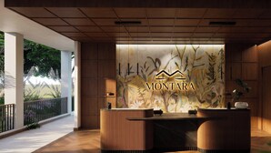 A reception desk with a floral mural and the name 'MONTARA' in the center. - Montara Hotel, Tapestry Collection by Hilton (Ángeles)