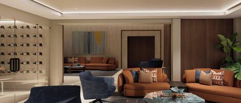 A modern living room with sofas, a coffee table, and a large abstract painting.