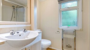 A bathroom with a sink, toilet, and shower. - Superior Lodge with ensuite & decking (Near Weymouth)