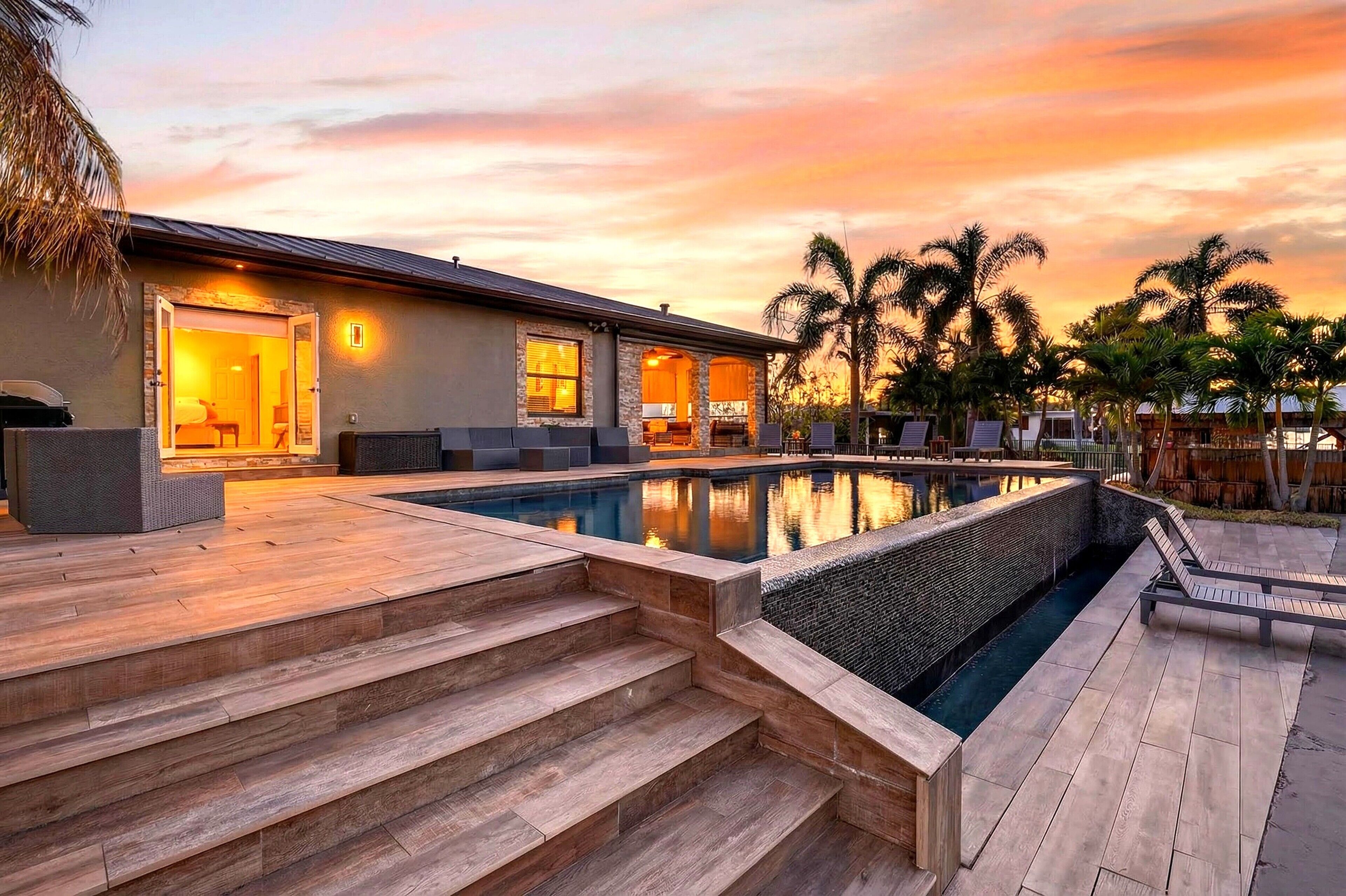 Waterfront living with a private dock, pool and lush tropical surroundings.