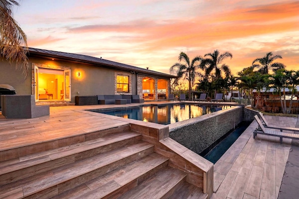 Waterfront living with a private dock, pool and lush tropical surroundings.