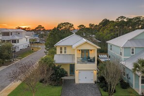 A two-story house with a garage, a balcony, and a driveway. - Sleeps 16 | Mins to Miramar Beach + Community Pool | Sea Love by AvantStay (Miramar Beach)