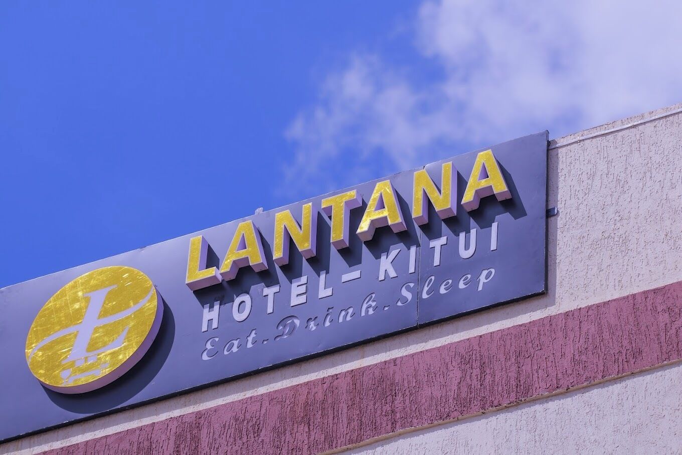 A sign for the LANTANA HOTEL-KITUI, featuring a prominent logo and the text "Eat Drink Sleep".