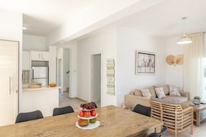 A modern kitchen with white cabinets and a built-in refrigerator. - 4 bedroom villa by Fig tree bay beach (Protaras)
