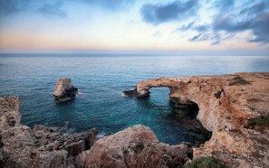 A coastal landscape with natural rock formations and a clear view of the sea. - 4 bedroom villa by Fig tree bay beach (Protaras)