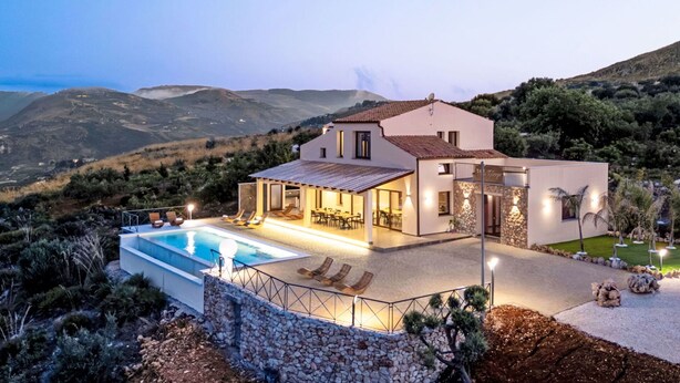 A modern villa with a swimming pool, outdoor seating, and a view of the surrounding hills. - Wonderful private villa for 15 guests with private pool, WIFI, A/C, TV and terrace (Custonaci)