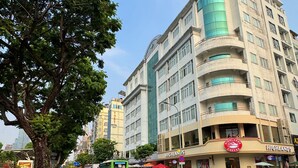 A multi-story hotel with a modern design, featuring balconies and large windows. - Came House - Near Bui Vien street (Ho Chi Minh City)