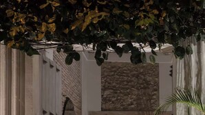 A staircase with a stone wall and a view of a pool area. - NOK Luxury Colonial Villa 6BR With Pool Staff Breakfast at Getsemani (Cartagena)