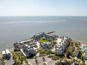 A coastal residential area with multiple two-story houses, a central courtyard, and a view of the ocean. - 660 Newhaven (Fripp Island)