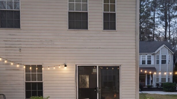 A two-story house with a patio area featuring outdoor furniture and a fire pit. - The Red Door Condo ATL managed by The REZORT Group (College Park)