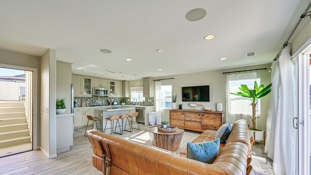 A spacious living area with a leather sofa, a wooden coffee table, and a TV mounted on the wall. - 1 Mi to Beach! San Clemente Gem w/ Rooftop Patios (San Clemente)