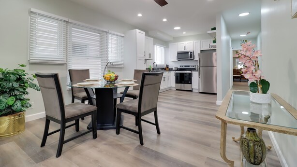 A modern kitchen with white cabinets, a microwave, and a stainless steel refrigerator. - 1 Mile to Henry Ford Hospital! Renovated Rental (Detroit)