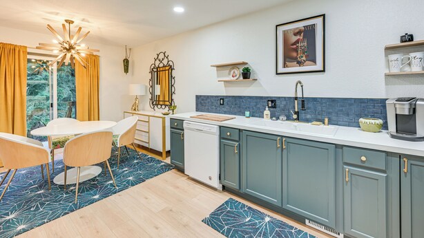 A modern kitchen with a white countertop, teal cabinets, and a blue backsplash. - Mcm-inspired Decor & Top Location! Tumwater Duplex (Olympia)