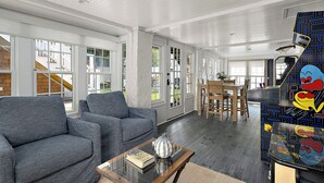 A spacious living area with a sofa, a coffee table, and a patterned wall.