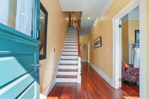 A staircase with wooden steps and white railings, leading to a landing with a door. - Savannah Home, Walkable to Forsyth, Historic (Savannah)