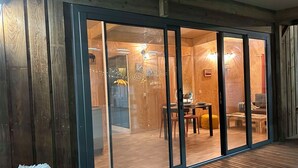 Et moderne interiør med trægulv, et spiseområde med bord og stole, og et hyggeligt opholdsområde med sofa og sofabord.