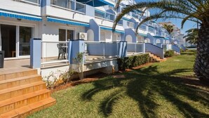 A multi-story hotel with balconies, a swimming pool, and a well-maintained lawn. - Charming 2-Bedroom Apartment in Denia, Beach Access, Parking Included (Denia)