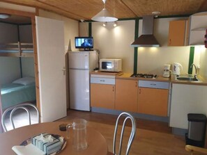 Fridge, microwave, coffee/tea maker, cookware/dishes/utensils