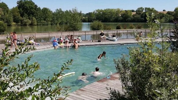 A swimming pool surrounded by a wooden deck with people swimming and relaxing. - Chalet for 6 with Terrace and Equipped Kitchen (Lamontjoie)